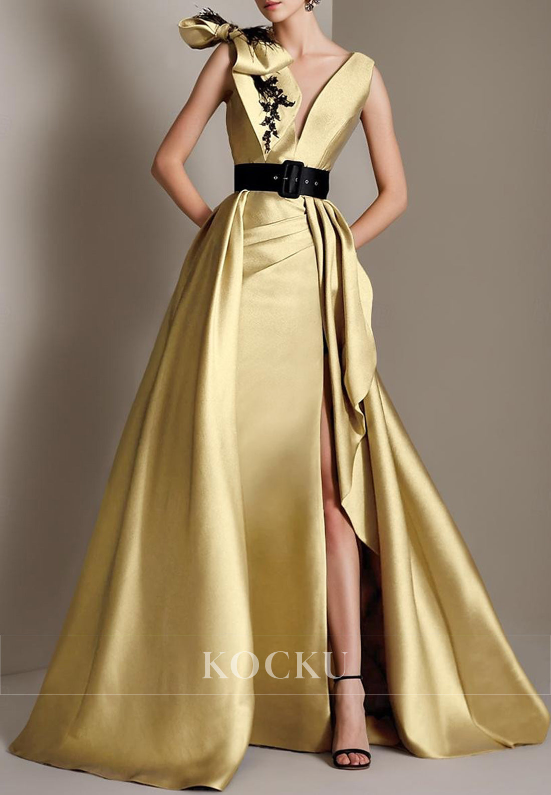 Glamorous Sleeveless Gold Gown with Deep V - Neck, Black Belt and Feather - Embellished Bow
