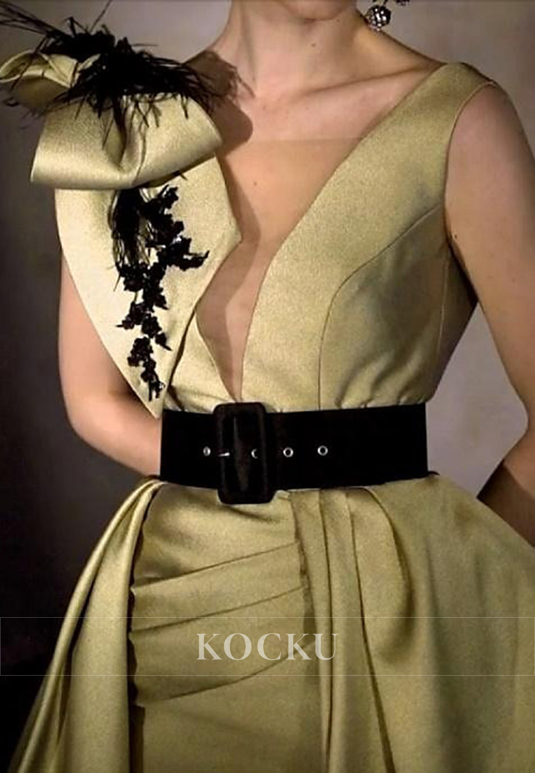Glamorous Sleeveless Gold Gown with Deep V - Neck, Black Belt and Feather - Embellished Bow